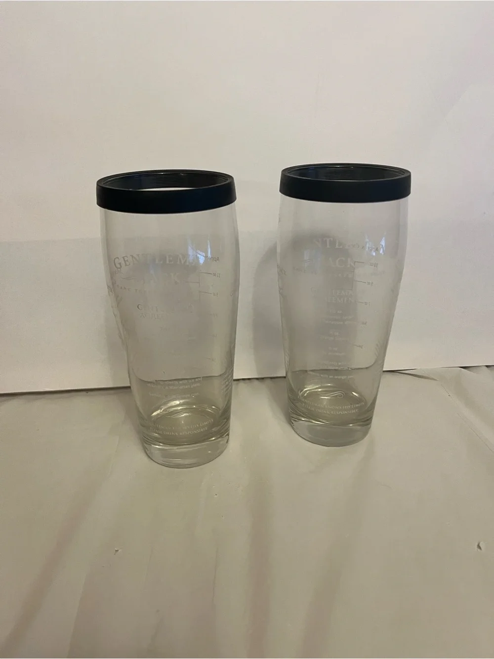 2,Gentleman Jack brand glass cocktail shaker with a recipe printed on the side.